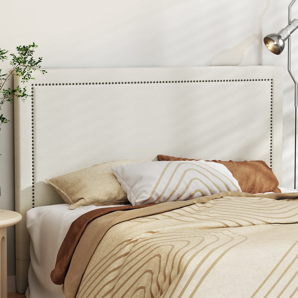 Rive upholstered bed head by Artiss in faux linen fabric with nailhead trim and high-density foam, designed for modern bedroom comfort and style.