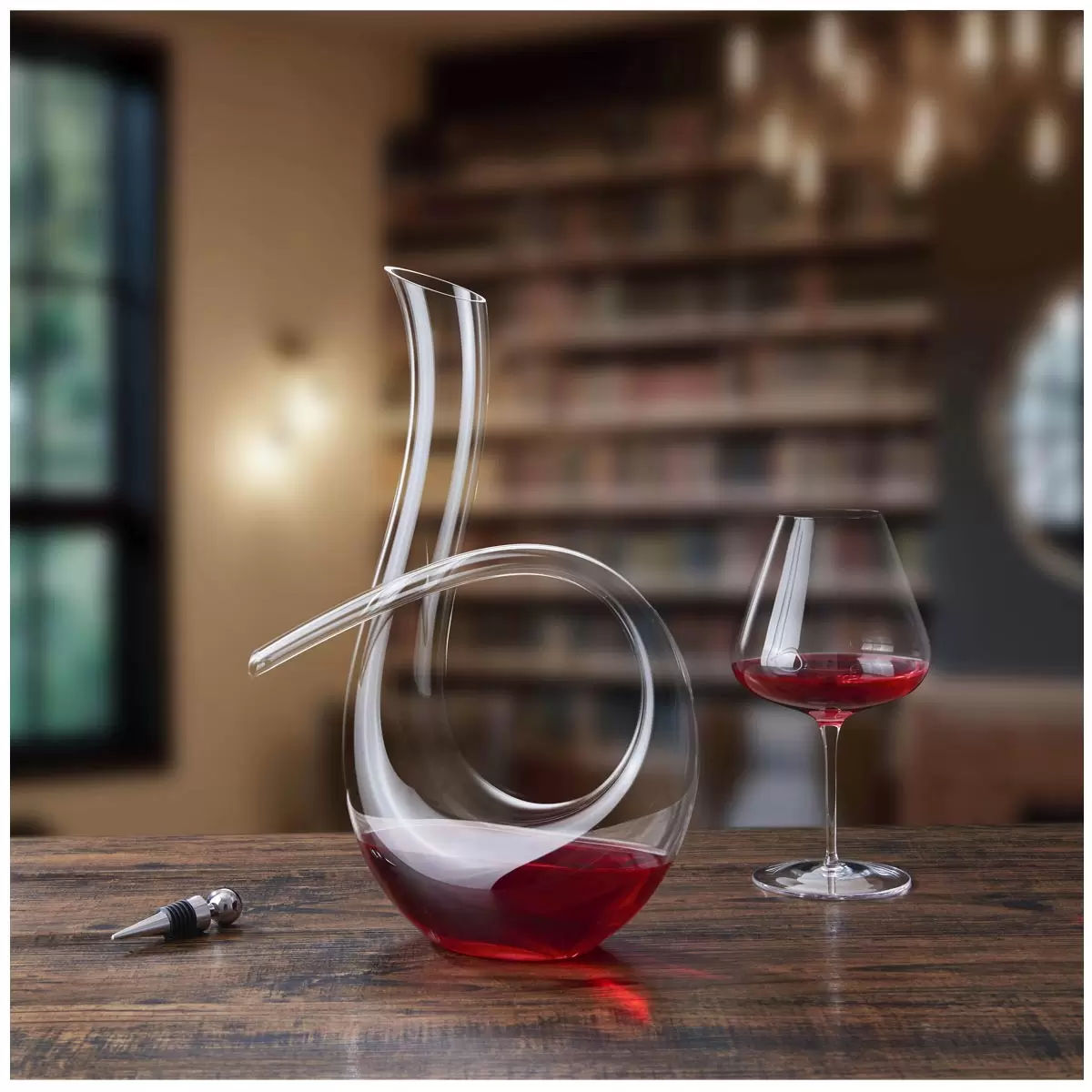 Elegant 1.2-litre glass wine decanter with a curved, swan-like shape, designed to aerate wine. Made from clear, lead-free glass with a smooth, handcrafted finish